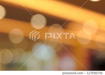 Soft warm golden light bokeh circles creating a beautiful abstract background texture effect 127696748