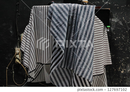 Striped Barber Capes Hanging in Barbershop Striped Barber Capes Hanging in Barbershop 127697102