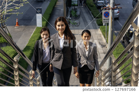 Team leadership businesswoman walking together on street city life. Group of business people team leader woman power. Multiethnic asian people step up urban lifestyle. Crowd Women walking up stair Team leadership businesswoman walking together on street city life. Group of business people team leader woman power. Multiethnic asian people step up urban lifestyle. Crowd Women walking up stair 127697166