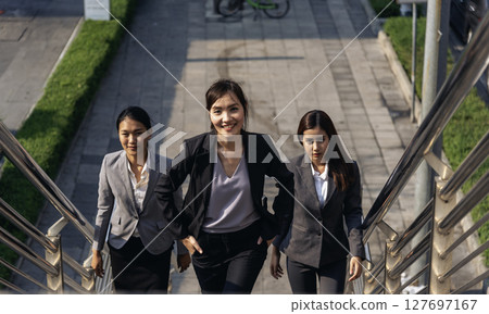 Team leadership businesswoman walking together on street city life. Group of business people team leader woman power. Multiethnic asian people step up urban lifestyle. Crowd Women walking up stair Team leadership businesswoman walking together on street city life. Group of business people team leader woman power. Multiethnic asian people step up urban lifestyle. Crowd Women walking up stair 127697167