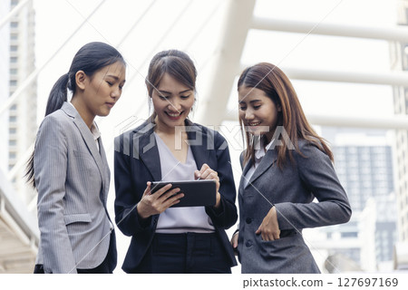 Businesswomen Partner use digital tablet online meeting team Partnership businesswoman talking together. Diversity group Asian Business women Partner trust teamwork. Asian Business team using tablet 127697169