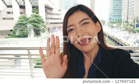Portrait Businesswoman arms crossed smiling look at camera in modern city background. Happy Business people positive achievement standing and smile. Happy leader executive young asian women leader Portrait Businesswoman arms crossed smiling look at camera in modern city background. Happy Business people positive achievement standing and smile. Happy leader executive young asian women leader 127697185