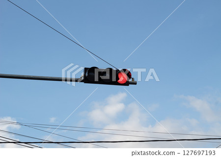 Red Traffic Light Against Blue Sky Red Traffic Light Against Blue Sky 127697193