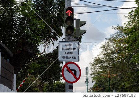 Red Traffic Light Against Blue Sky 127697198