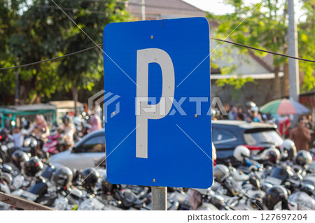 Parking Sign in a Busy Motorcycle Lot Parking Sign in a Busy Motorcycle Lot 127697204
