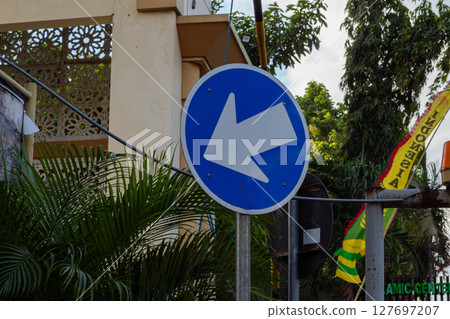 Blue Left Turn Traffic Sign in Urban Setting Blue Left Turn Traffic Sign in Urban Setting 127697207