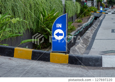 Blue IN Direction Sign With Left Arrow 127697220