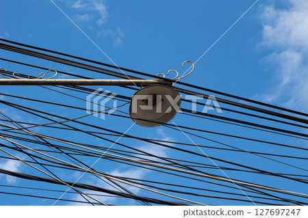 Electricity Network and Lighting Against Sky Background Electricity Network and Lighting Against Sky Background 127697247
