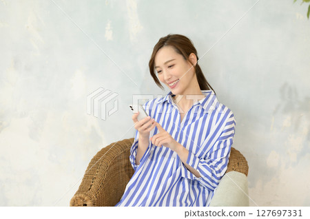 Woman operating a smartphone 127697331