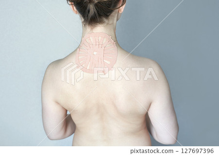 Female with shoulder pain relief patch on back for therapeutic treatment Female with shoulder pain relief patch on back for therapeutic treatment 127697396