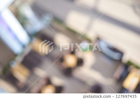 Blurred aerial view of outdoor seating area with tables and chairs in natural 127697435