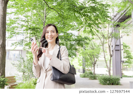 Business woman checking on smartphone Business woman checking on smartphone 127697544