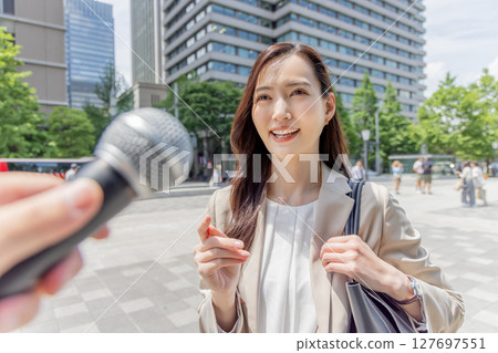 A woman undergoing a street interview 127697551
