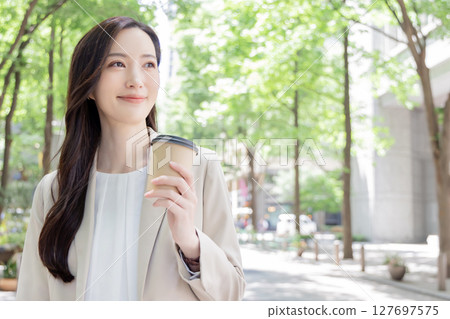 Female taking out coffee 127697575