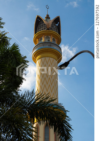 Islamic Architecture: Ornate Minaret with Gold Accents 127697592