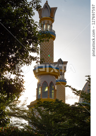 Islamic Architecture: Ornate Minaret with Gold Accents 127697597
