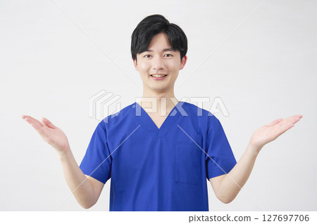 Doctor, nurse, dentist, caregiver, man pointing left and right with palm, white background Doctor, nurse, dentist, caregiver, man pointing left and right with palm, white background 127697706
