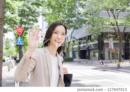 Business woman calling a taxi Business woman calling a taxi 127697813