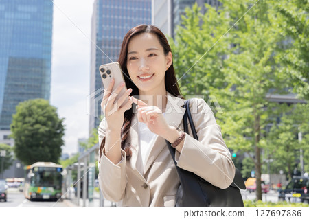 A woman operating a smartphone A woman operating a smartphone 127697886