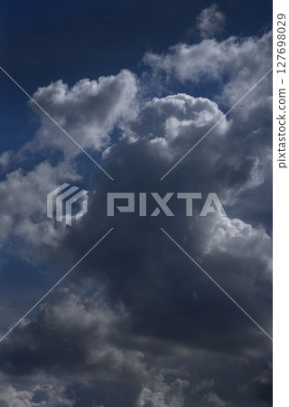 Vertical Dramatic dark storm rain clouds black sky background. Dark thunderstorm clouds rainny atmosphere. windstorm disasters climate. Dust ominous cloudscape storm disaster gloomy gray cloud sky 127698029