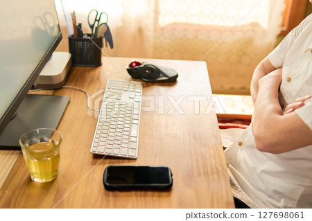 A man in his 50s staring at a computer screen and thinking A man in his 50s staring at a computer screen and thinking 127698061