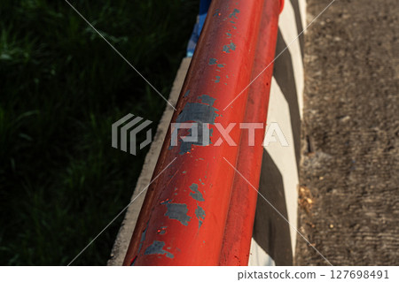 Red Metal Railing with Peeling Paint - Close-up Detail Red Metal Railing with Peeling Paint - Close-up Detail 127698491
