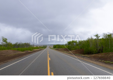 Empty highway in rural area with green bush on sides. Empty highway in rural area with green bush on sides. 127698640