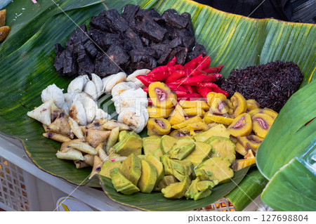 Assortment of Traditional Indonesian Snacks on Banana Leaf 127698804