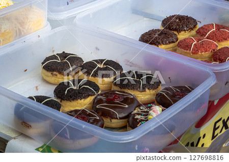 Assortment of Sweet Donuts in Plastic Container 127698816