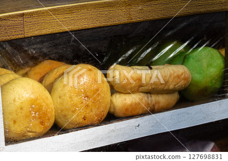 Assorted Local Breads and Pastries in Display Case 127698831