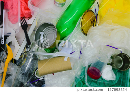 Mix of plastic, metal, glass, carton and other trash background surface which are most polluting Earth 127698854