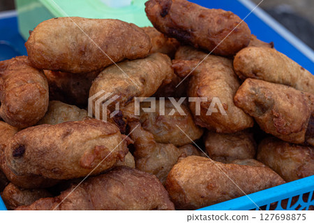 Assortment of Indonesian Fried Snacks at a Street Food Stall 127698875