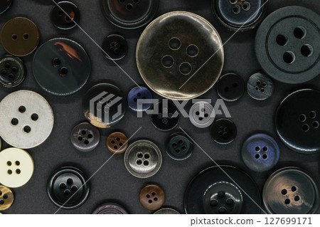 Various dark clothes buttons background Various dark clothes buttons background 127699171