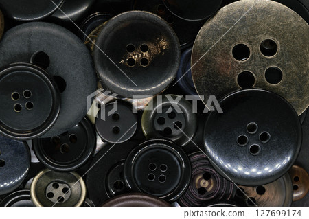 Various dark clothes buttons background 127699174