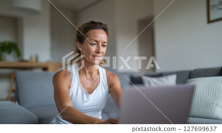 Mature woman practicing mindfulness meditation at home for mental wellness 127699637