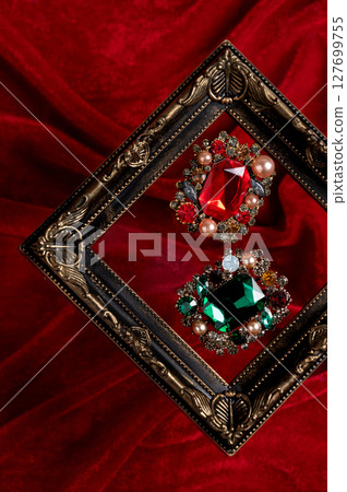 Red and green jewelry on a red background 127699755