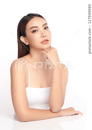 A beautiful young Asian woman with clean, fresh skin against a white background. Skincare, facial treatment, cosmetology, beauty, and spa. An elegant portrait of an Asian woman. A beautiful young Asian woman with clean, fresh skin against a white background. Skincare, facial treatment, cosmetology, beauty, and spa. An elegant portrait of an Asian woman. 127699980