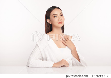 A beautiful young Asian woman with clean, fresh skin against a white background. Skincare, facial treatment, cosmetology, beauty, and spa. An elegant portrait of an Asian woman. A beautiful young Asian woman with clean, fresh skin against a white background. Skincare, facial treatment, cosmetology, beauty, and spa. An elegant portrait of an Asian woman. 127699997