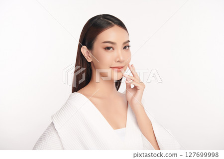 A beautiful young Asian woman with clean, fresh skin against a white background. Skincare, facial treatment, cosmetology, beauty, and spa. An elegant portrait of an Asian woman. A beautiful young Asian woman with clean, fresh skin against a white background. Skincare, facial treatment, cosmetology, beauty, and spa. An elegant portrait of an Asian woman. 127699998