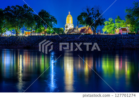 light on the Nan River and Chedi of Prang Wat Phra Si Rattana Mahathat also colloquially at the Nan River and the park at night in Phitsanulok, Thailand. 127701274