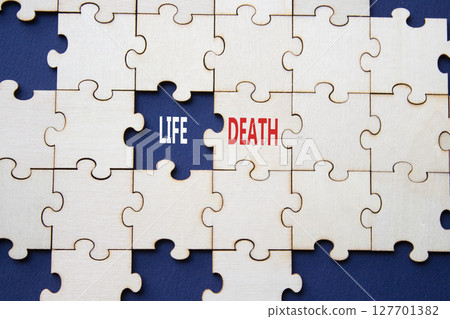 Life or Death symbol. Concept word Life or Death on wooden puzzle. Beautiful deep blue background. Business and Life or Death concept. Copy space 127701382