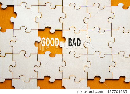 Good or Bad symbol. Concept word Good or Bad on wooden puzzle. Beautiful orange background. Business and Good or Bad concept. Copy space 127701385