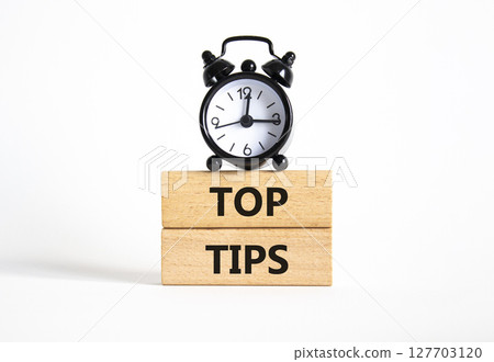 Top Tips symbol. Concept words Top Tips on wooden blocks. Beautiful white background with alarm clock. Business and Top Tips concept. Copy space. Top Tips symbol. Concept words Top Tips on wooden blocks. Beautiful white background with alarm clock. Business and Top Tips concept. Copy space. 127703120