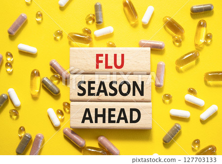 Flu Season Ahead symbol. Concept word Flu Season Ahead on wooden blocks. Beautiful yellow background with pills. Medicine and Flu Season Ahead concept. Copy space Flu Season Ahead symbol. Concept word Flu Season Ahead on wooden blocks. Beautiful yellow background with pills. Medicine and Flu Season Ahead concept. Copy space 127703133