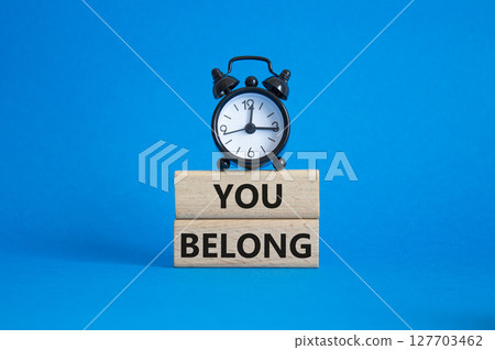 You belong symbol. Concept words You belong on wooden blocks. Beautiful blue background with alarm clock. Business and You belong concept. Copy space. You belong symbol. Concept words You belong on wooden blocks. Beautiful blue background with alarm clock. Business and You belong concept. Copy space. 127703462