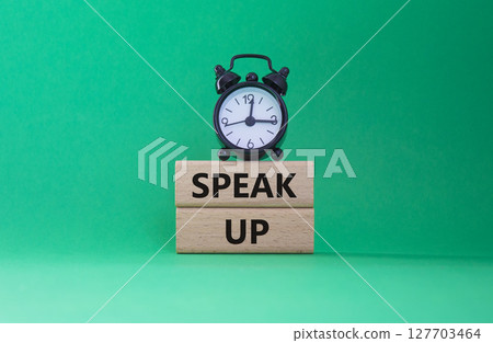 Speak Up symbol. Wooden blocks with words Speak Up Beautiful green background with alarm clock. Business and Speak Up concept. Copy space. Speak Up symbol. Wooden blocks with words Speak Up Beautiful green background with alarm clock. Business and Speak Up concept. Copy space. 127703464