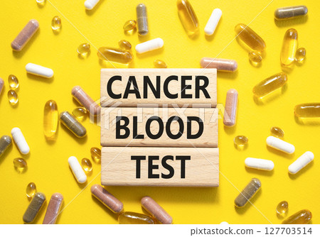 Cancer Blood Test symbol. Concept word Cancer Blood Test on wooden blocks. Beautiful yellow background with pills. Medicine and Cancer Blood Test concept. Copy space 127703514