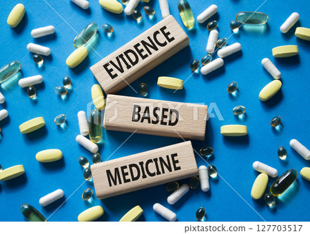 Evidence Based Medicine symbol. Concept word Evidence Based Medicine on wooden blocks. Beautiful blue background with pills. Medicine and Evidence Based Medicine concept. Copy space Evidence Based Medicine symbol. Concept word Evidence Based Medicine on wooden blocks. Beautiful blue background with pills. Medicine and Evidence Based Medicine concept. Copy space 127703517