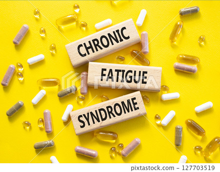 Chronic Fatigue Syndrome symbol. Concept word Chronic Fatigue Syndrome on wooden blocks. Beautiful yellow background with pills. Medicine and Chronic Fatigue Syndrome concept. Copy space Chronic Fatigue Syndrome symbol. Concept word Chronic Fatigue Syndrome on wooden blocks. Beautiful yellow background with pills. Medicine and Chronic Fatigue Syndrome concept. Copy space 127703519