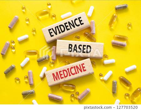 Evidence Based Medicine symbol. Concept word Evidence Based Medicine on wooden blocks. Beautiful yellow background with pills. Medicine and Evidence Based Medicine concept. Copy space Evidence Based Medicine symbol. Concept word Evidence Based Medicine on wooden blocks. Beautiful yellow background with pills. Medicine and Evidence Based Medicine concept. Copy space 127703520